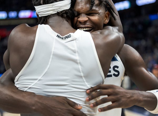 Anthony Edwards (1) and Patrick Beverley (22) of the Minnesota Timberwolves celebrate at the end of the game Tuesday, April 12, at Target Center in Mi