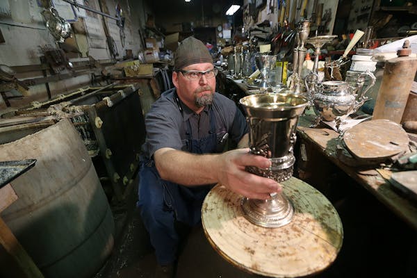 St. Paul silversmith Vern Vanderpoel eyed a 16th century piece to look for indentations at Brinkmans Silver Plating and Repair, Wednesday, September 7