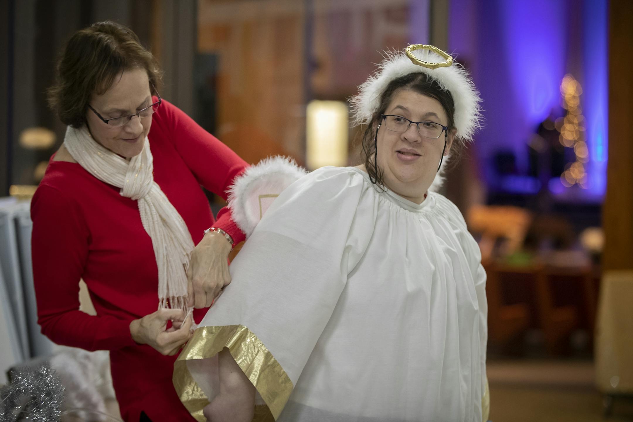 Maggie Knox, who is a volunteer with Christ for People with Developmental Disabilities, helped dress all the angels, including Mia Cook, who participated in the nativity pageant at Meadow Creek Church, Thursday, November 29, 2018 in Andover, MN.