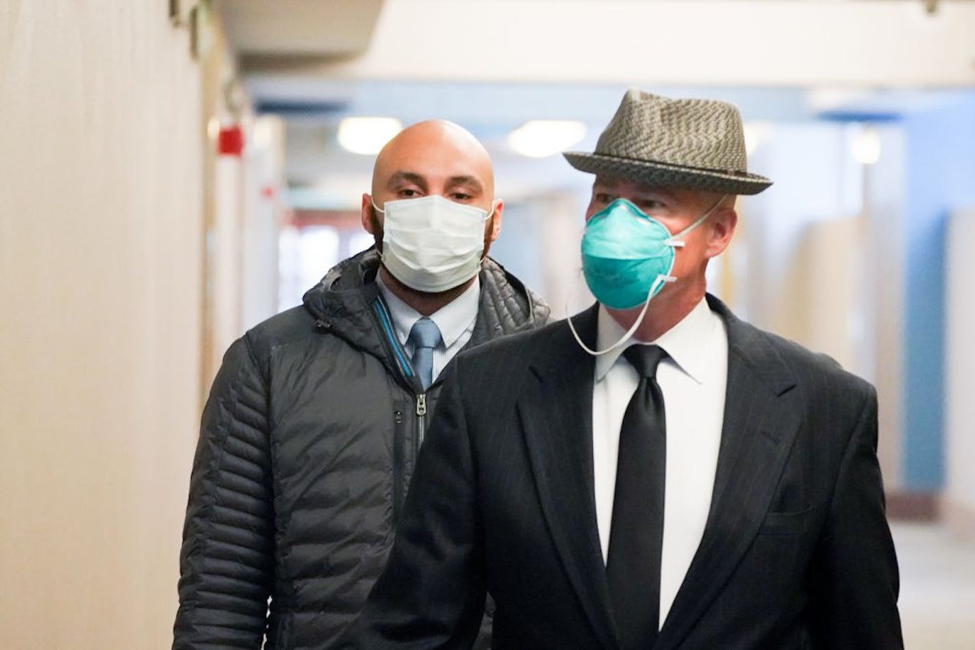 Former Minneapolis police officer J. Alexander Kueng, left, entered the Hennepin County Public Safety Facility Monday morning with his attorney Thomas Plunkett, right.