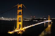The Golden Gate Bridge at night, with San Francisco in the distance, is seen from Battery Spencer near the Marin Headlands of Marin County, Calif. Pho