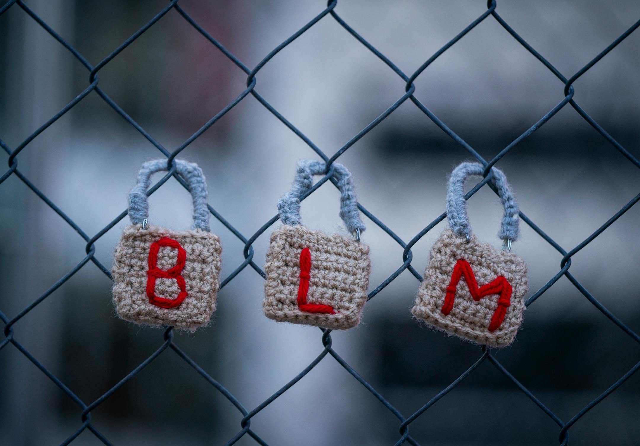 Crocheted locks indicating BLM or Black Live Matter are hung on the fence outside the Hennepin County Government Center during the Locks for Loved Ones Lost: Part II event.