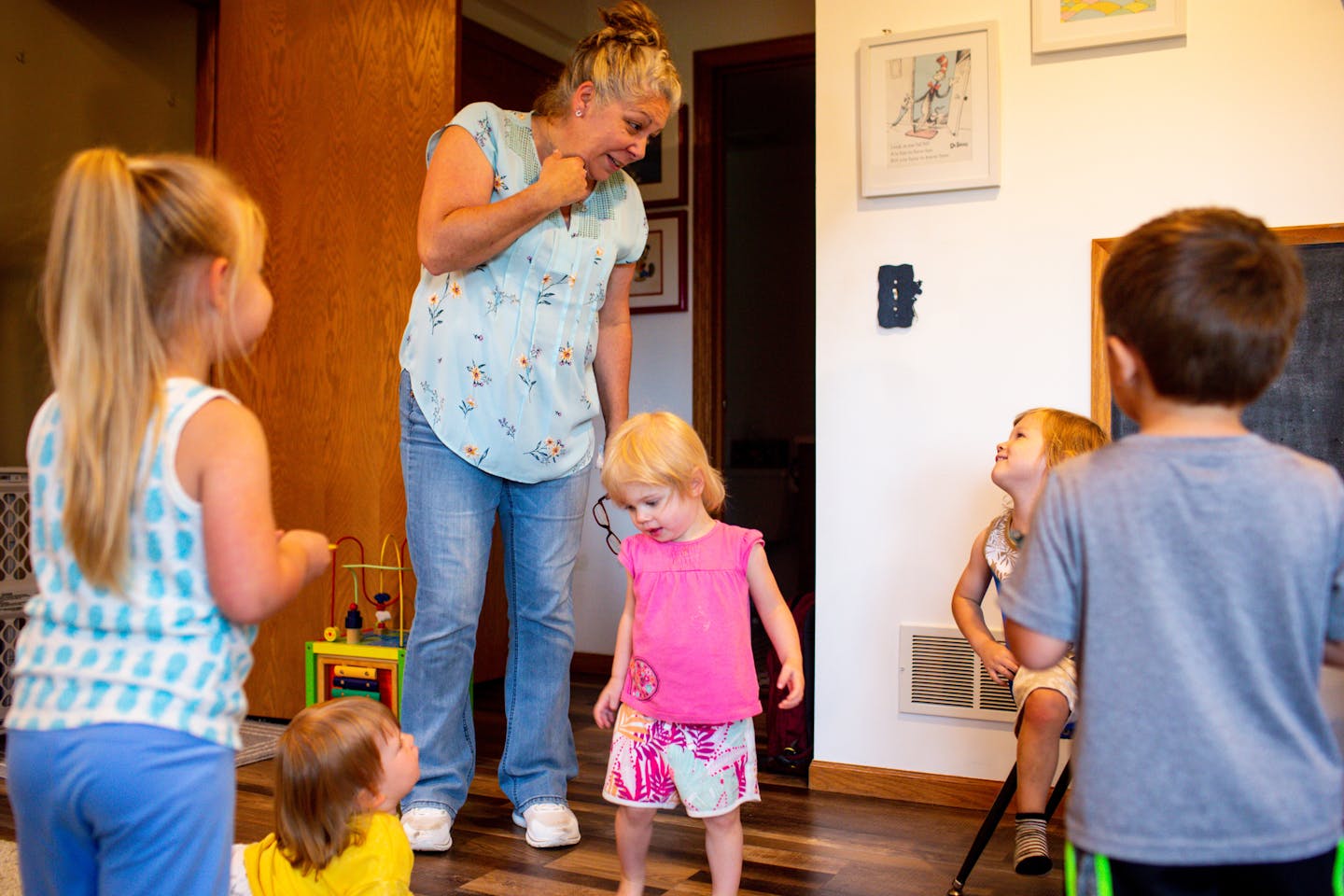 Julie Seydel plays with the children under her care at her Kozy Kids home daycare center Monday in Andover.