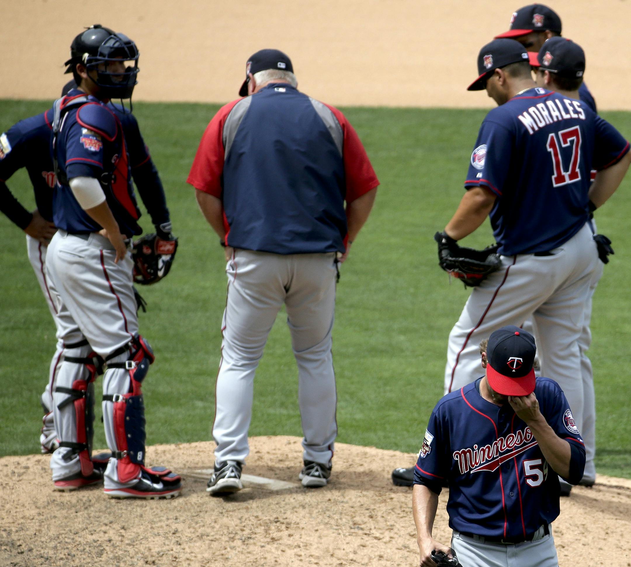 Minnesota Twins relief pitcher Matt Guerrier walks off the field after giving up two hits against the Los Angeles Angels during the seventh inning of a baseball game in Anaheim, Calif., Thursday, June 26, 2014. (AP Photo/Chris Carlson)