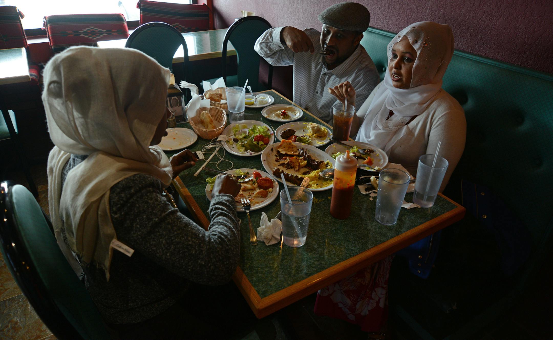 Fatima Mahamad of Minneapolis, Abdulha Fid Mohamud of Coon Rapids and Sadyo Hayow of Minneapolis shared a meal at the Filfillah Restaurant which features Middle Eastern food. ] Ethnic restaurants and grocery stores line Central Avenue in Columbia Heights, drawing community members and commuters alike to sample different cultures' cuisines. Richard.Sennott@startribune.com Richard Sennott/Star Tribune Columbia Heights , Minn. Tuesday 3/11/2014) ** (cq)