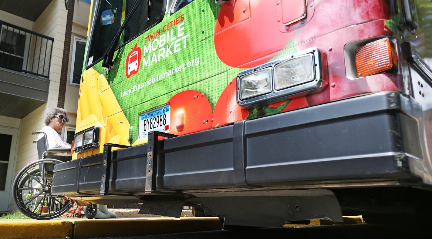 Linda Thomas waited outside the bus in her wheelchair as Janet McKay gathered her groceries on The Wilder mobile market bus Tuesday July 14, 2015 in St Paul, MN. ] Jerry Holt/ Jerry.Holt@Startribune.com