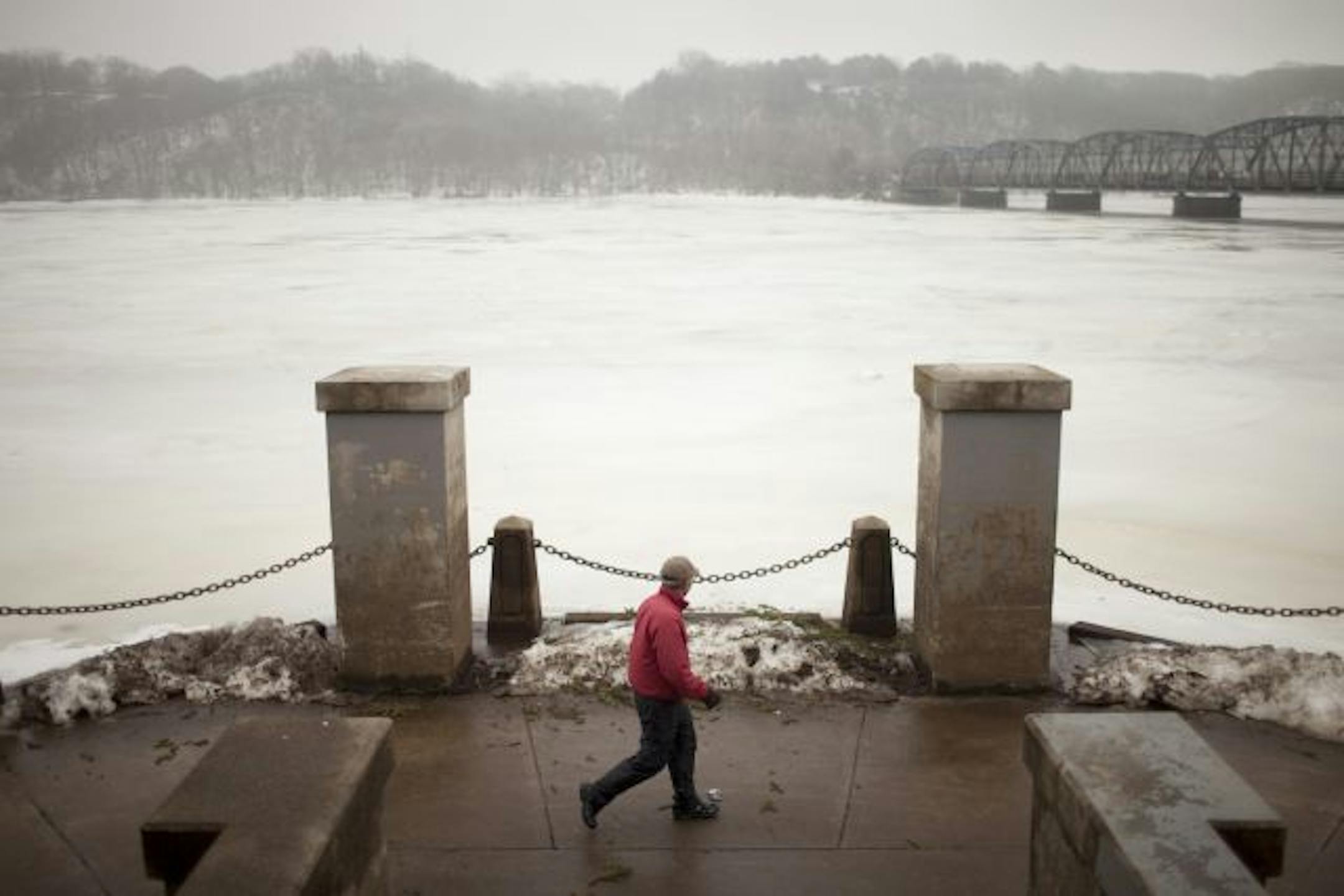 A welcome respite: Runners, walkers and bikers made their way around Lake Harriet on Thursday during a morning blanketed by heavy fog. Winter weather soon will return, adding to the potential for disastrous flooding in the spring.