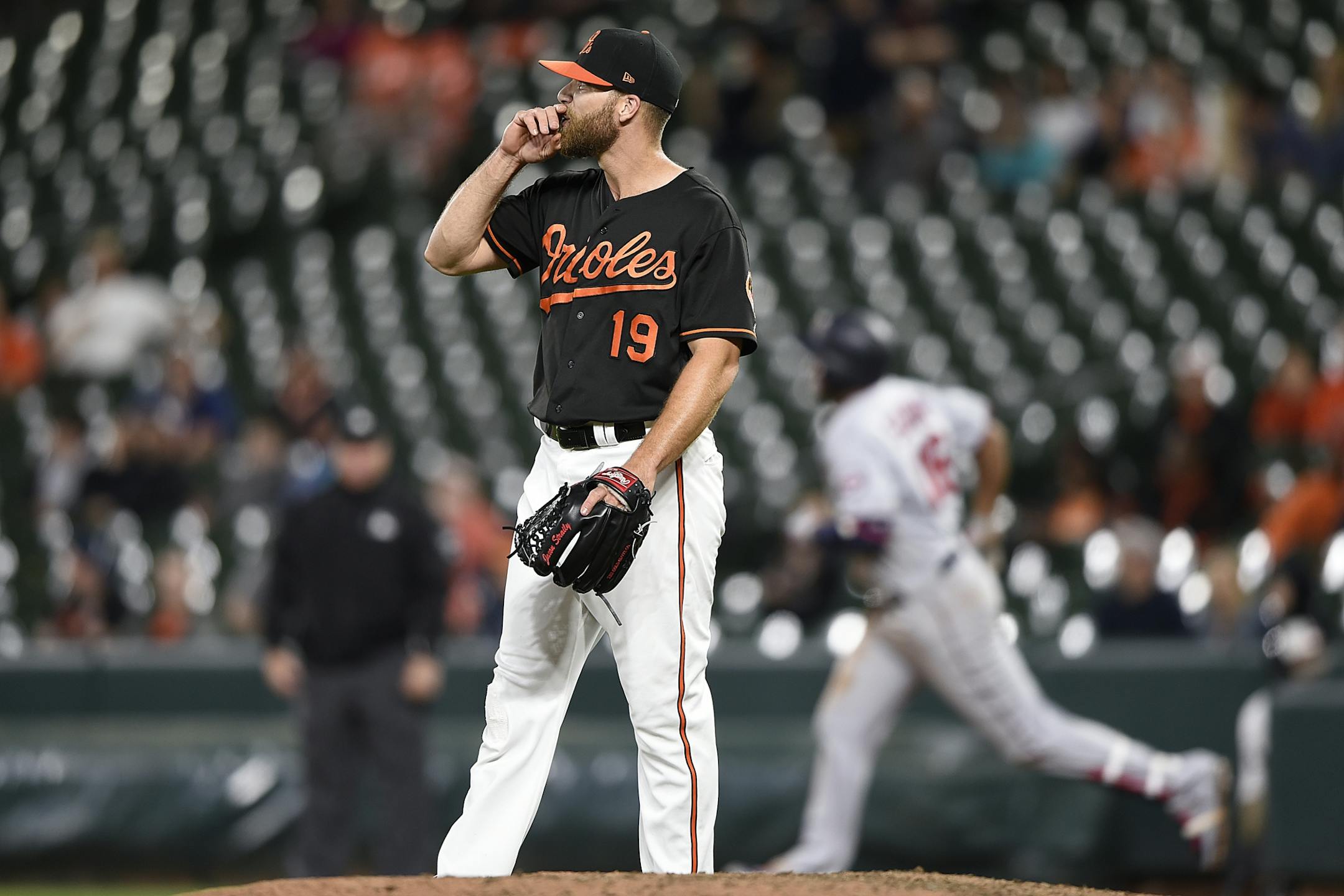 Baltimore Orioles' Chris Davis (19) pauses on the mound after giving up a solo home run to Minnesota Twins Jonathan Schoop, back right, in the ninth inning of the second game of a baseball doubleheader, Saturday, April 20, 2019, in Baltimore.