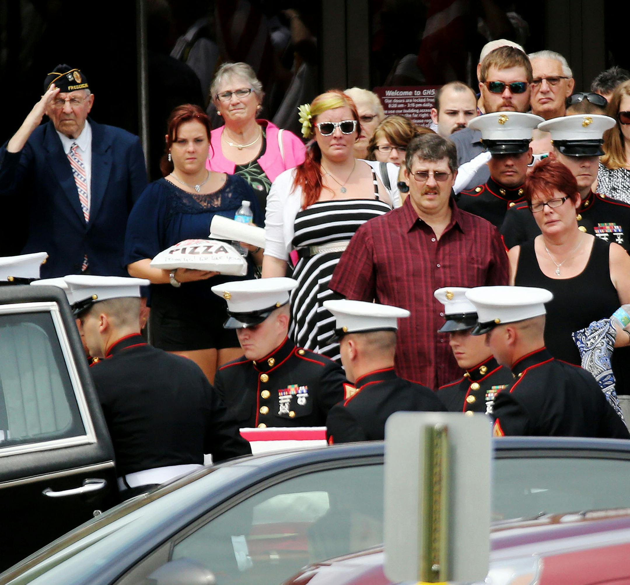 Grantsburg, Wisconsin said goodbye to U.S. Marine Sgt. Carson Holmquist, 25, with a visitation and public funeral at the Grantsburg High School Saturday, July 24, 2015, in Grantsburg, WI. Here, family and friends process behind as Holmquist's casket is loaded into a hearse outside the high school. ](DAVID JOLES/STARTRIBUNE)djoles@startribune.com Grantsburg, Wisconsin said goodbye to U.S. Marine Sgt. Carson Holmquist with a visitation and public funeral at the Grantsburg High School Saturday, Jul