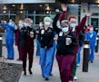 Regions Hospital healthcare workers came outside the hospital to thank Xcel Energy crew members who had gathered outside Regions Hospital to greet and