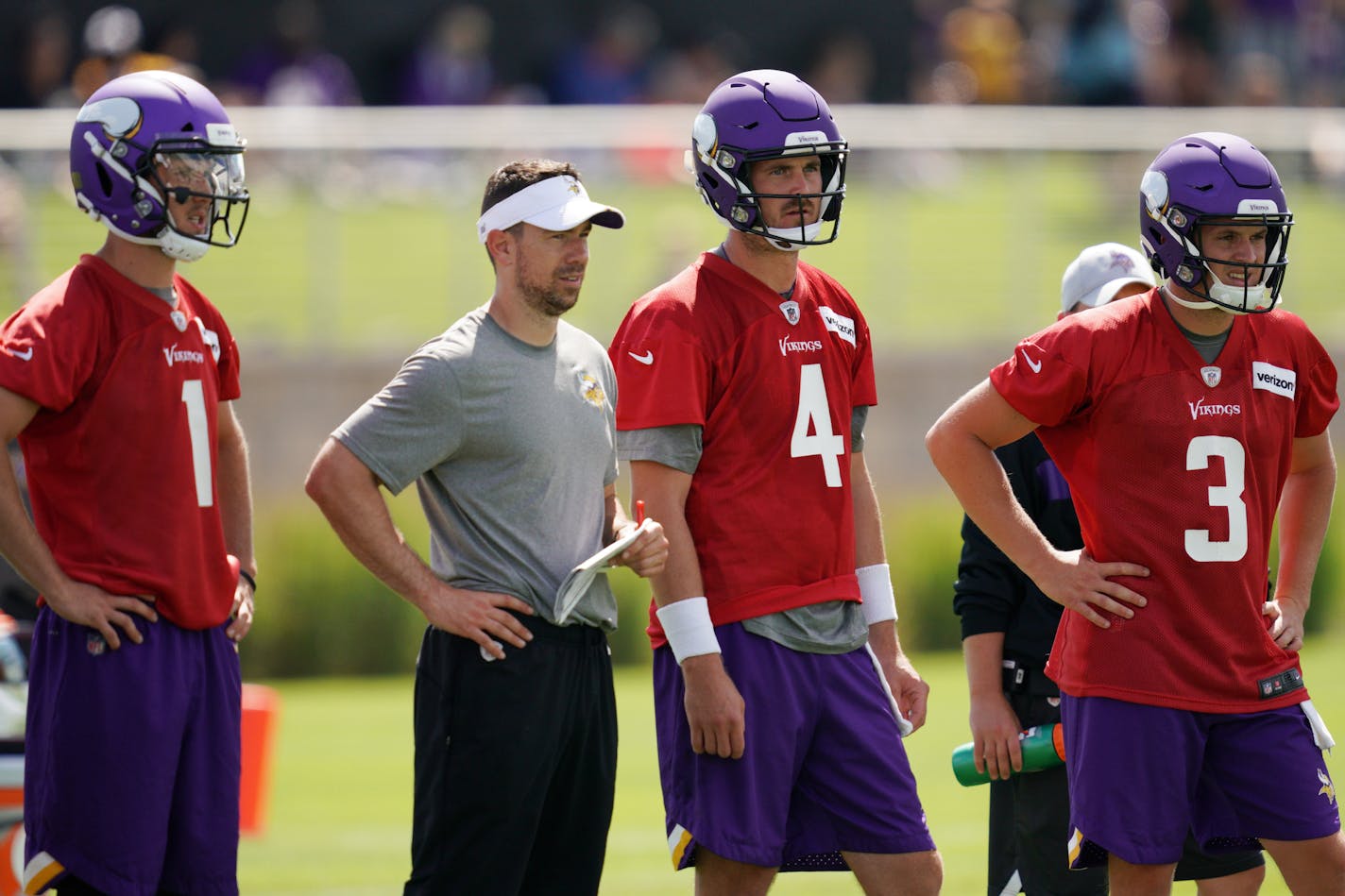 Vikings backup quarterbacks Kyle Sloter (1), Sean Mannion (4) and Jake Browning (3) gathered with quarterbacks coach Klint Kubiak to watch drills during training camp Friday.