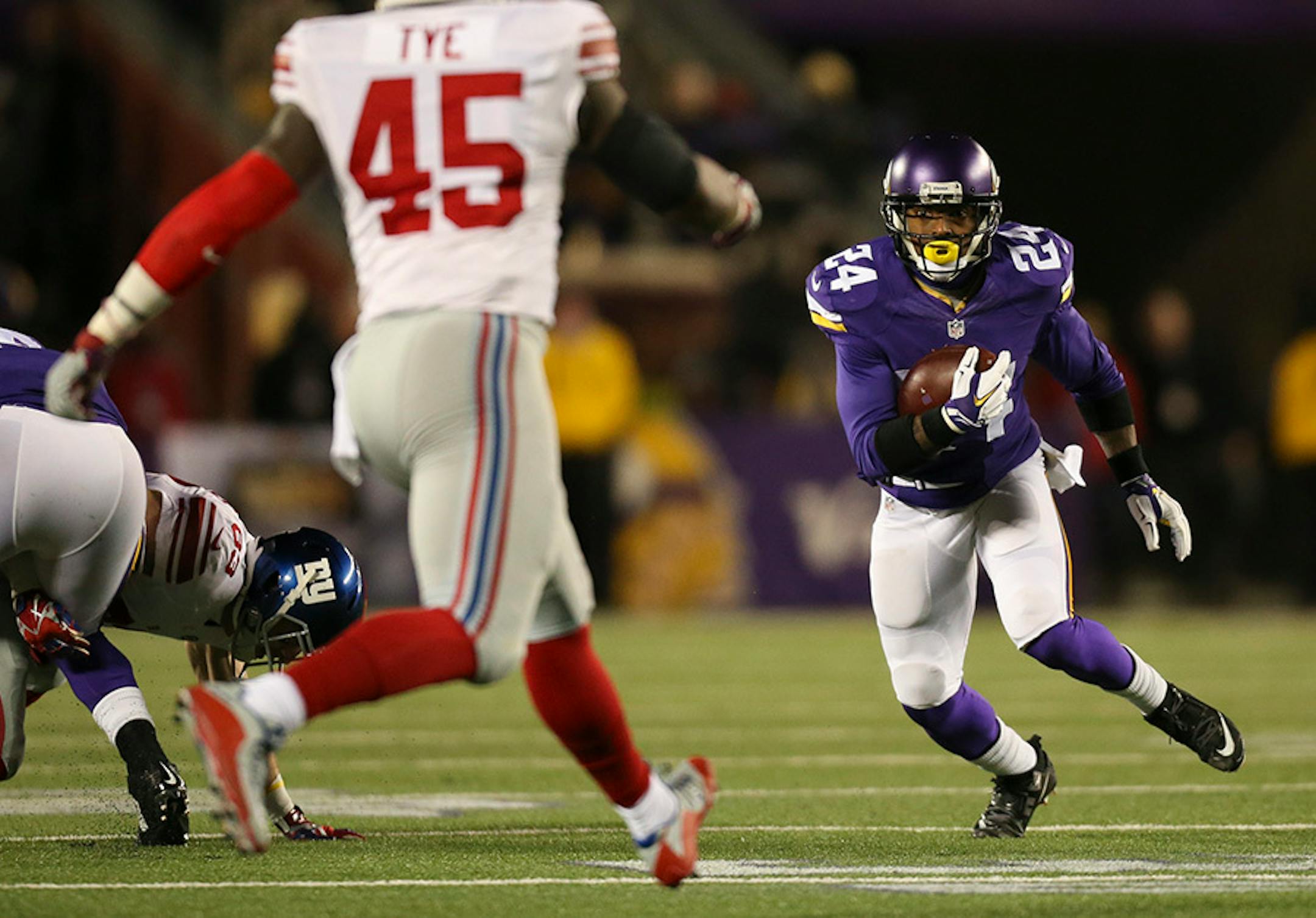 Vikings cornerback Captain Munnerlyn (24) looked for daylight after intercepting a pass in the third quarter Sunday night. He returned it for 32 yards, setting up a Vikings TD.