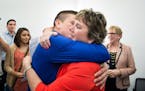 Judge Anne McKeig hugged her son Balam after she was appointed to the Minnesota Supreme Court. Behind her are son Xicotencatl, daughter Itzel and, on 