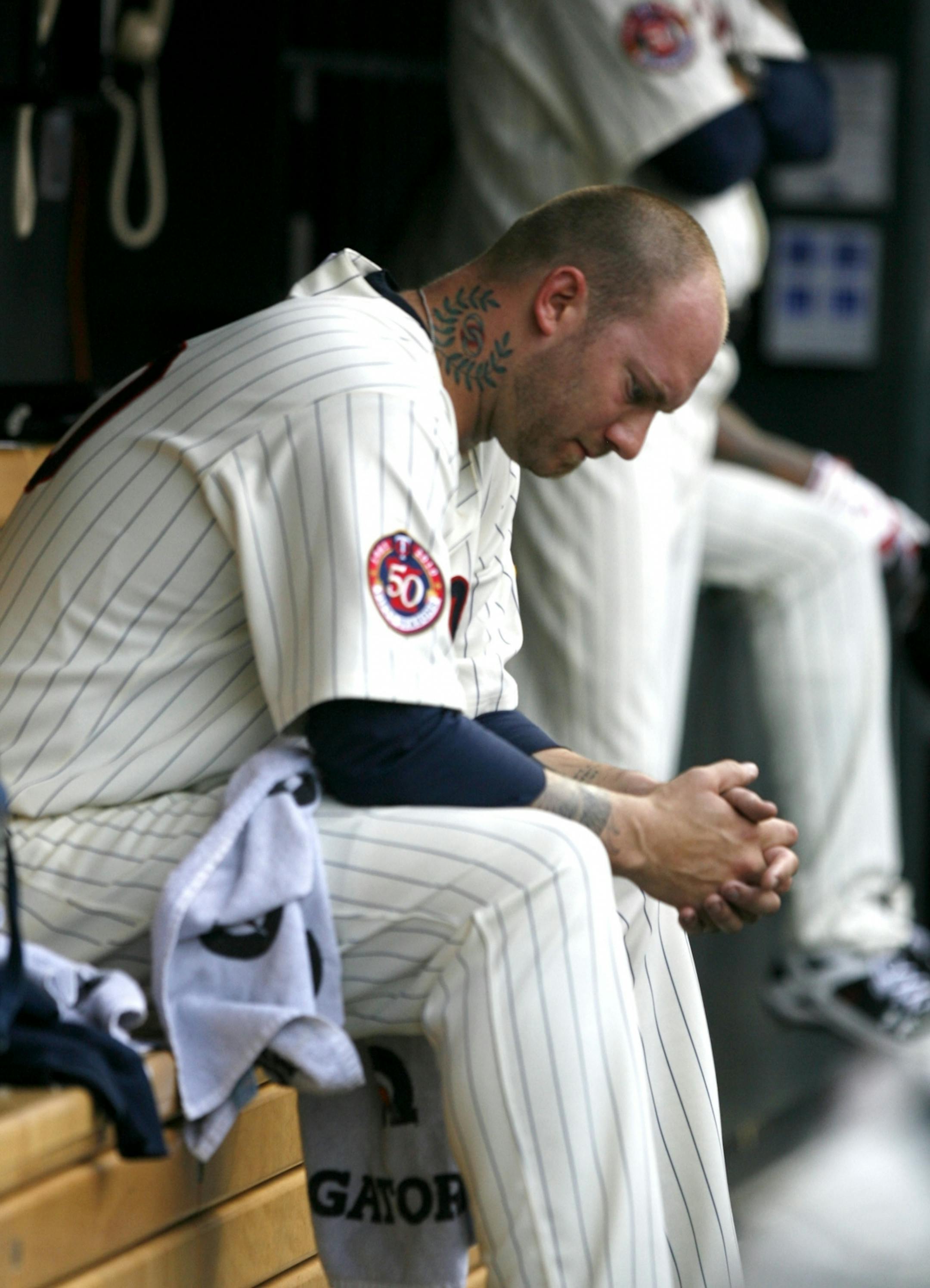 Twins closer Jon Rauch sat in the dugout after failing to shut down the Brewers in the ninth inning.