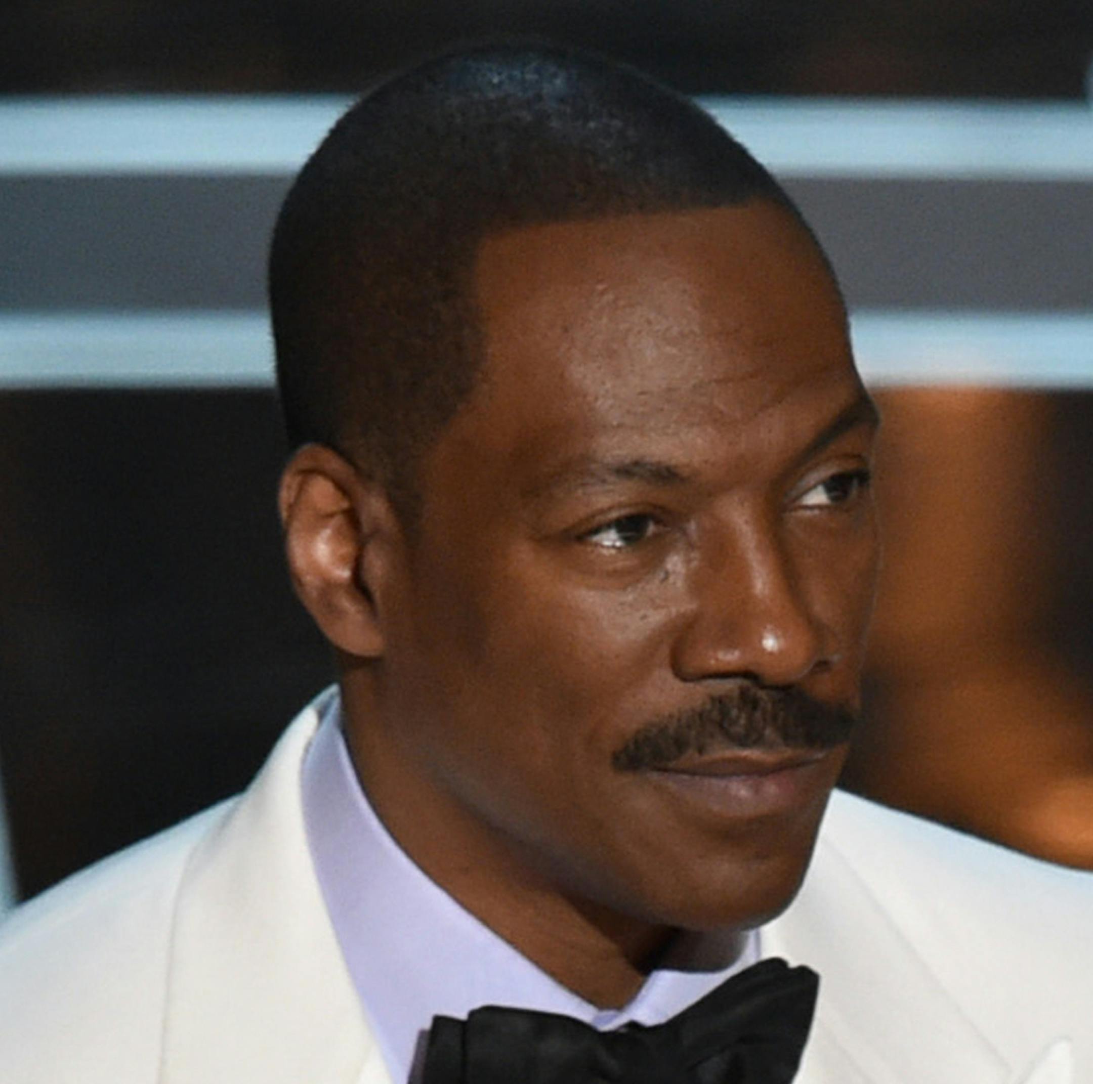 FILE - In this Feb. 22, 2015 file photo, Eddie Murphy presents the award for best original screenplay at the Oscars at the Dolby Theatre in Los Angeles. Chris Rock, Kathy Griffin, Arsenio Hall and other leading comedians will perform Sunday, Oct. 18, in honor of Murphy as he receives the nation’s top prize for humor, the the Mark Twain Prize for American Humor, at the Kennedy Center in Washington. (Photo by John Shearer/Invision/AP, File)