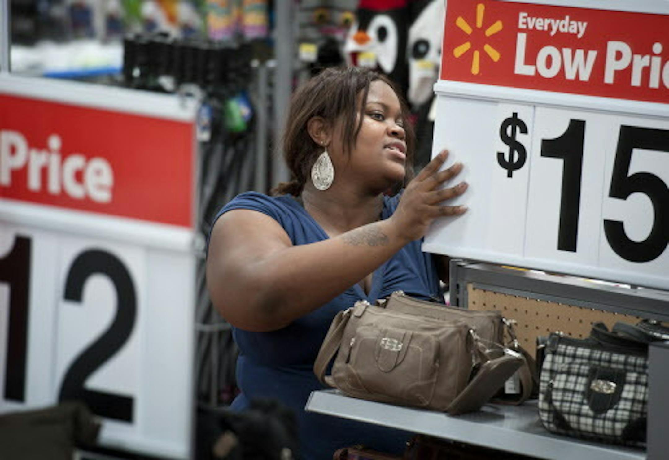 Loreal Stewart put signs on a display at Wal-Mart in Brooklyn Center.