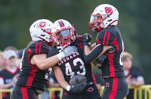 Centennial running back Maverick Harper (43) celebrates with offensive lineman Trenton Campbell (54) and tight end Kellen Binder (86) after scoring a touchdown against Blaine in the first quarter Friday, Sep. 08, 2023, at Centennial High School in Circle Pines, Minn. ]