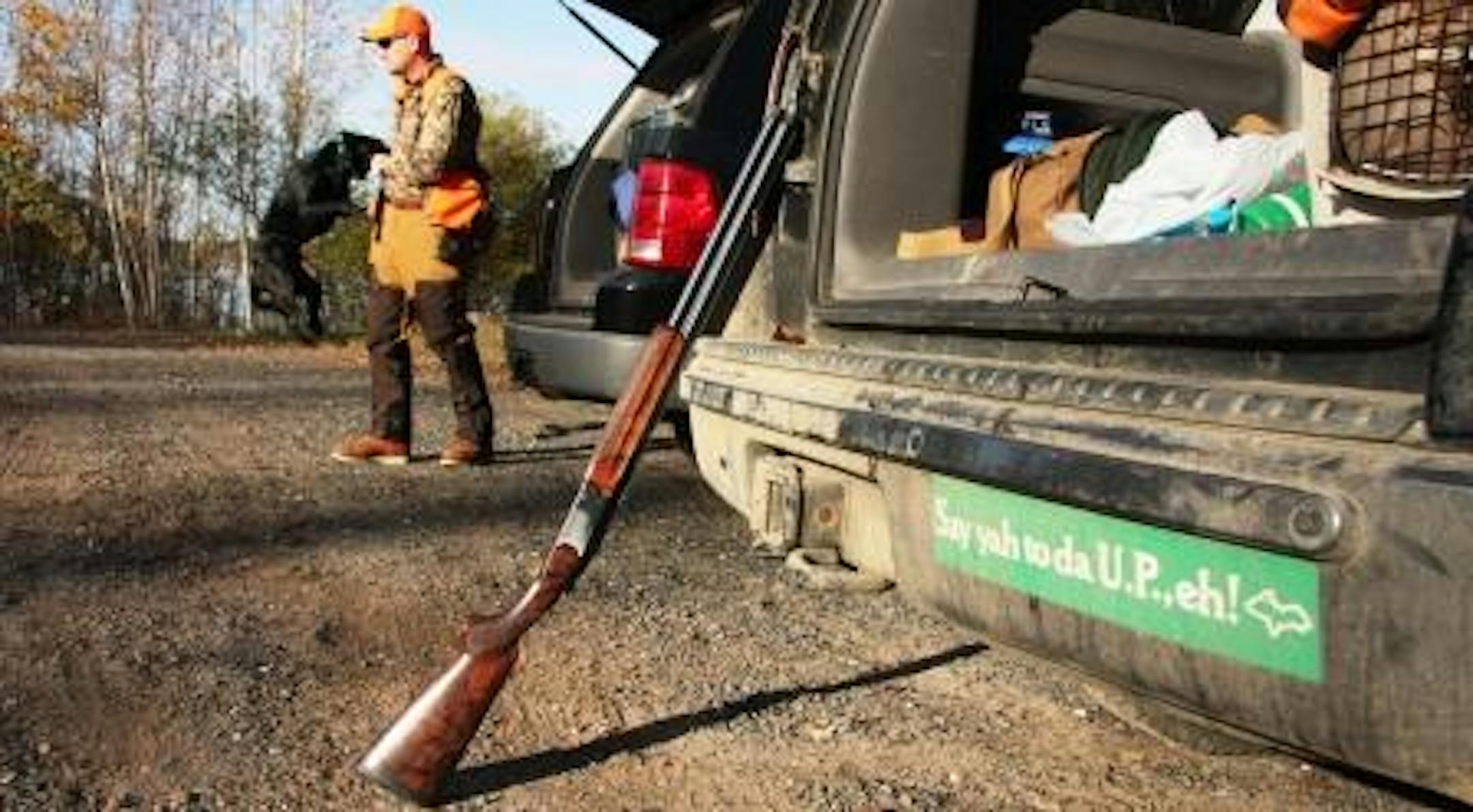 Matt Kucharski and his Lab, Lucy, prepare for a forest hunt in Michigan's U.P.