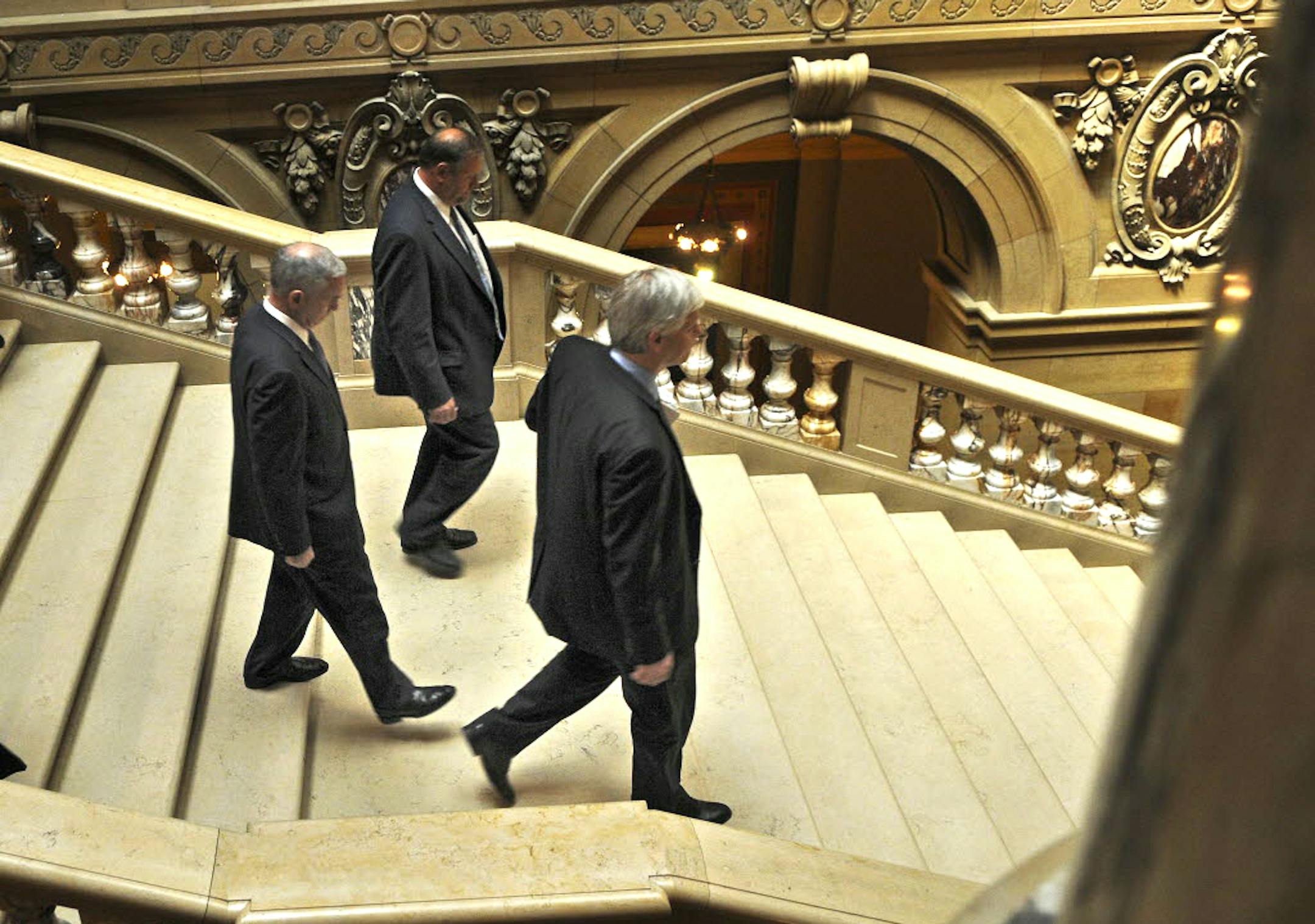 Gov. Mark Dayton and Tom Bakk, Senate Minority Leader, and Paul Thissen, House Minority Leader, walked down the stairs after Tuesday's final budget meeting.