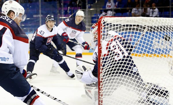 Phil Kessel (81) shot the puck past Slovakia goalie Peter Dudaj (31) for a goal in the second period. USA beat Slovakia by a final score of 7-1.