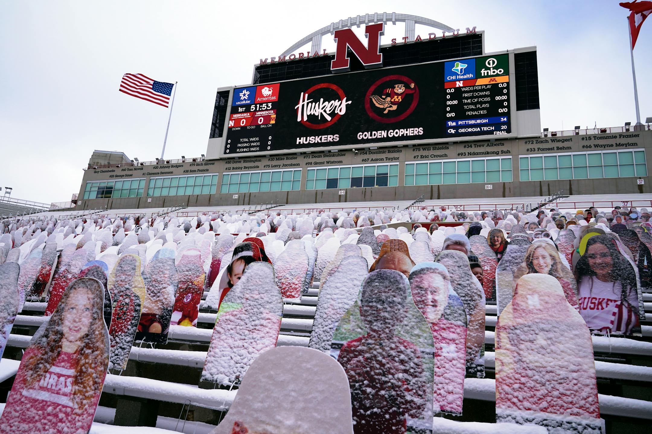 Snow-covered cutouts of fans are seen in the stands prior to an NCAA college football game between Nebraska and Minnesota, in Lincoln, Neb., Saturday, Dec. 12, 2020. (AP Photo/Nati Harnik)