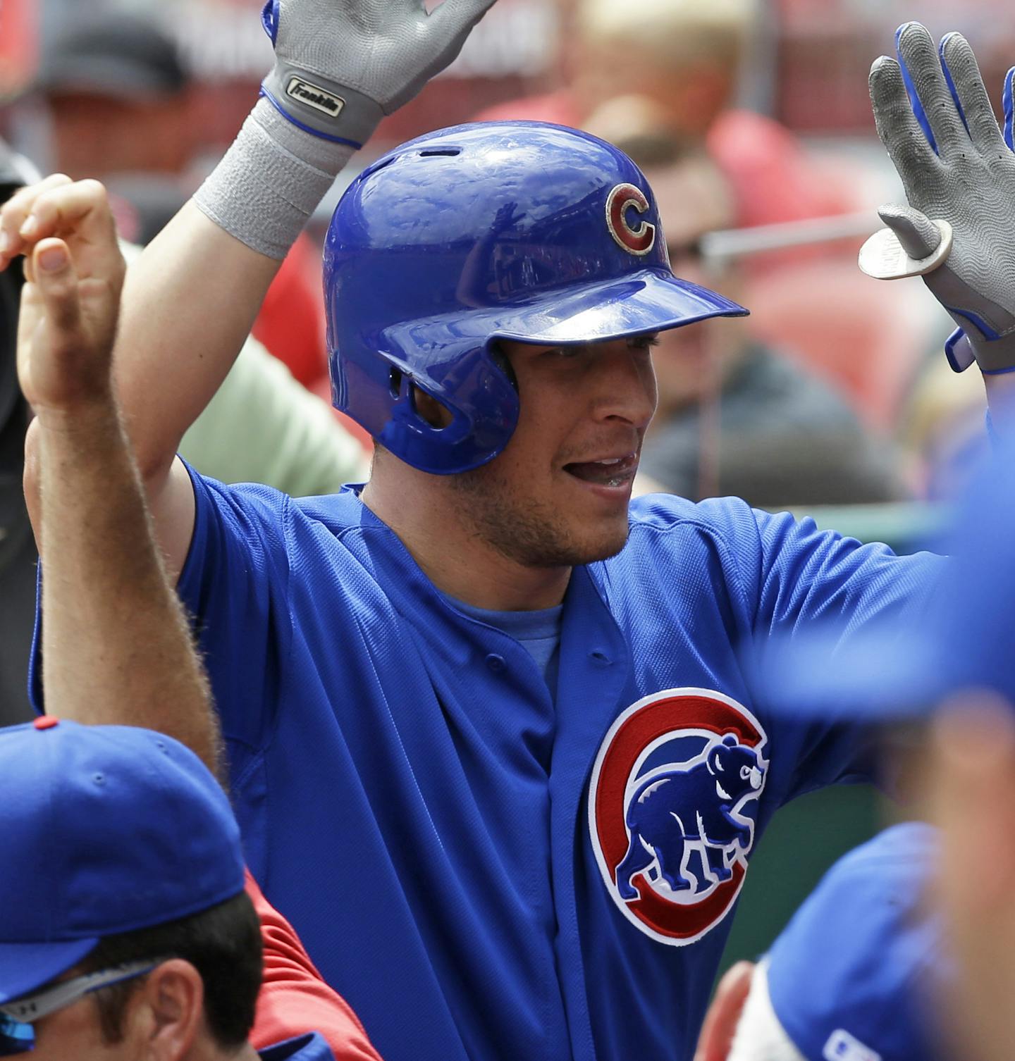 Chicago Cubs' Ryan Sweeney is congratulated in the dugout after hitting a solo home run off Cincinnati Reds starting pitcher Johnny Cueto in the sixth inning of a baseball game, Tuesday, July 8, 2014, in Cincinnati. (AP Photo/Al Behrman) ORG XMIT: CSA109