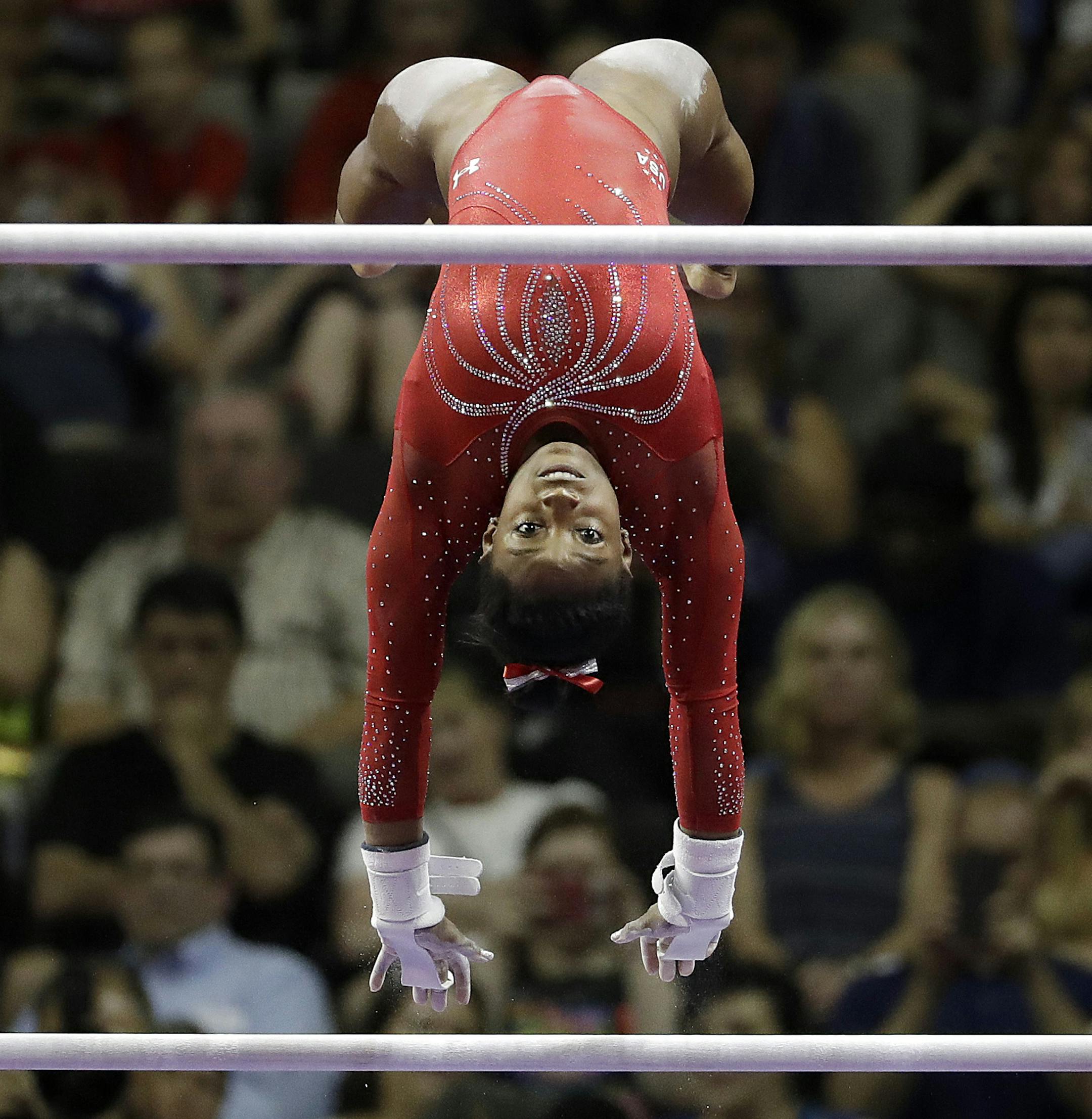 FILE- In this Sunday, July 10, 2016, file photo, Simone Biles competes on the uneven bars during the women's U.S. Olympic gymnastics trials in San Jose, Calif. It's not one thing, the artistry, the athleticism, the smile. It's all of it when it comes to Biles. Even Olympic champion Mary Lou Retton is in awe. "You can't teach that special unique quality that Simone has," Retton says. "And she's got it." (AP Photo/Gregory Bull, File) ORG XMIT: NY161