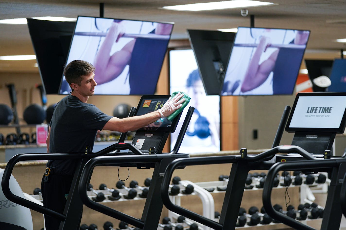 Bradley Carr cleaned exercise equipment at Life Time Fitness with Purell surface disinfectant more frequently on surfaces around the club. ] GLEN STUBBE &#x2022; glen.stubbe@startribune.com Wednesday, March 11, 2020 Workers at Life Time Fitness used Purell surface disinfectant more frequently on surfaces around the club.