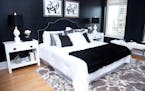 A black velvet headboard complements a bold black animal print embossed wallpaper in this master bedroom. (Hannah Rokes/Design Recipes) ORG XMIT: 1211