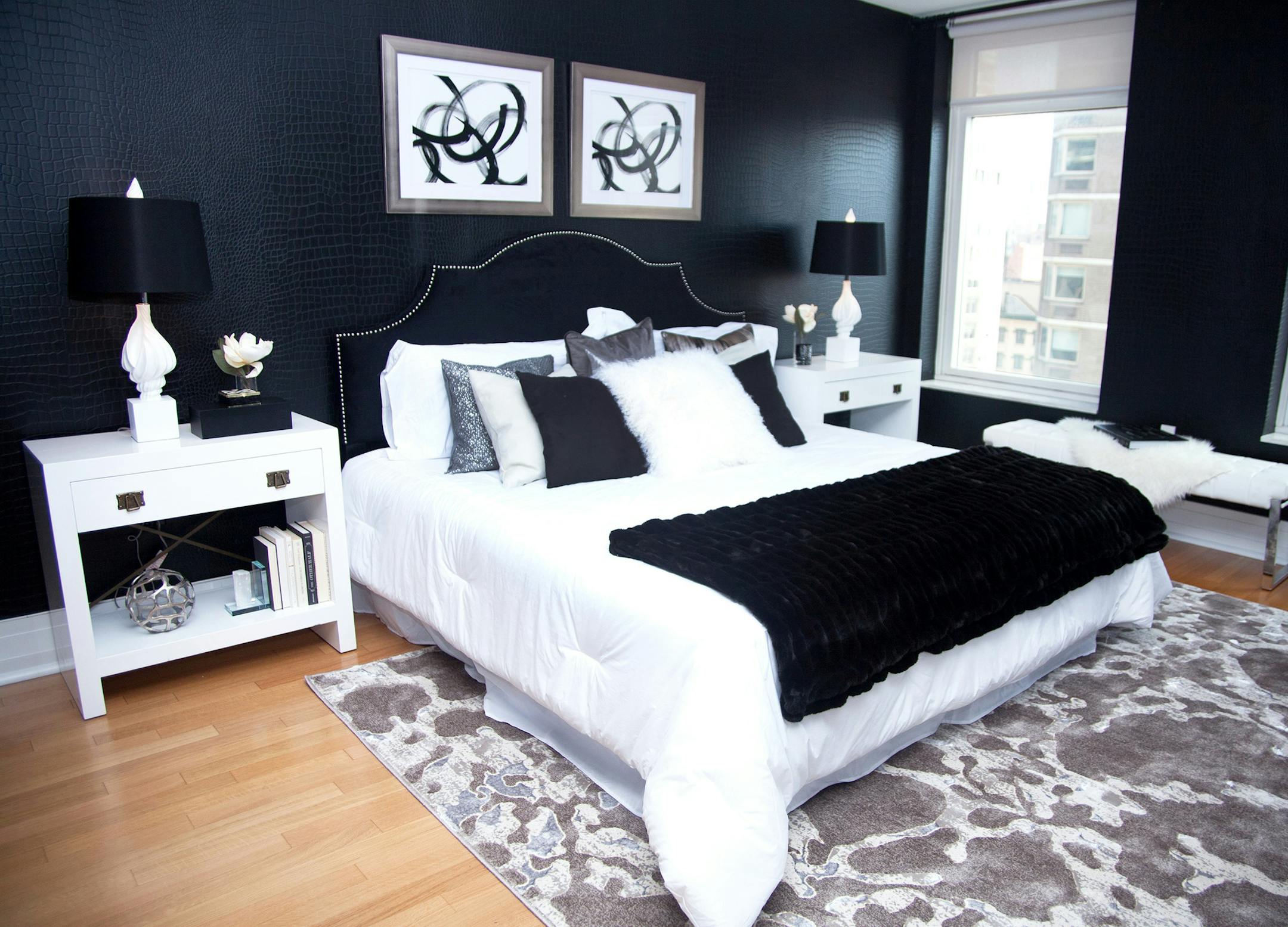 A black velvet headboard complements a bold black animal print embossed wallpaper in this master bedroom. (Hannah Rokes/Design Recipes) ORG XMIT: 1211003