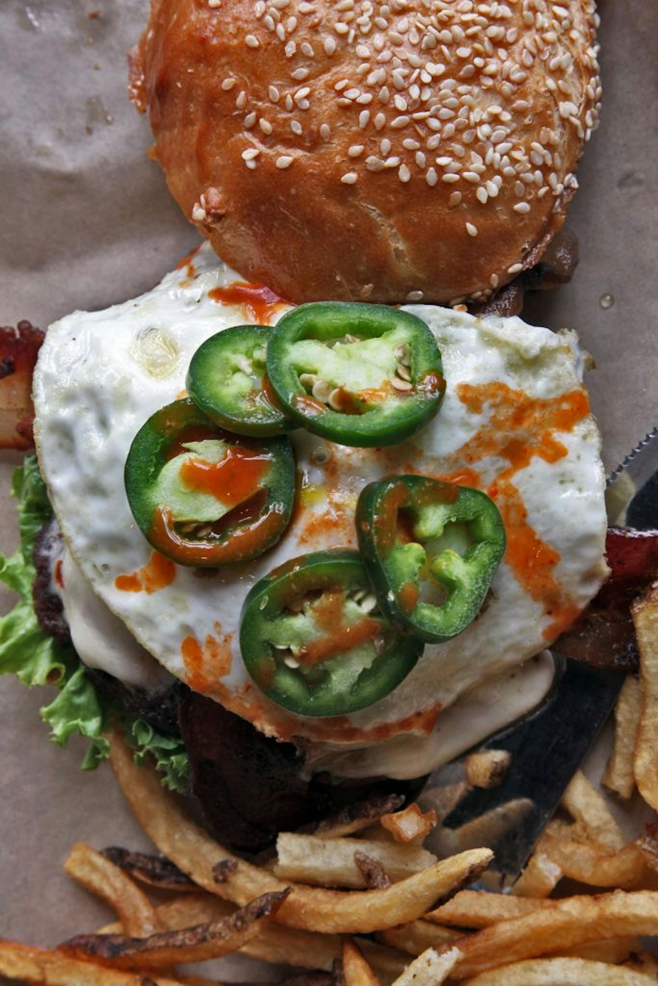A group of students from DECA, a business club at Burnsville High School, designed a burger called the Blaze Burger to be sold at Burger Jones restaurant in Burnsville. It features peanut butter jalapenos, hot sauce, pepper jack cheese and an egg. (MARLIN LEVISON/STARTRIBUNE(mlevison@startribune.com