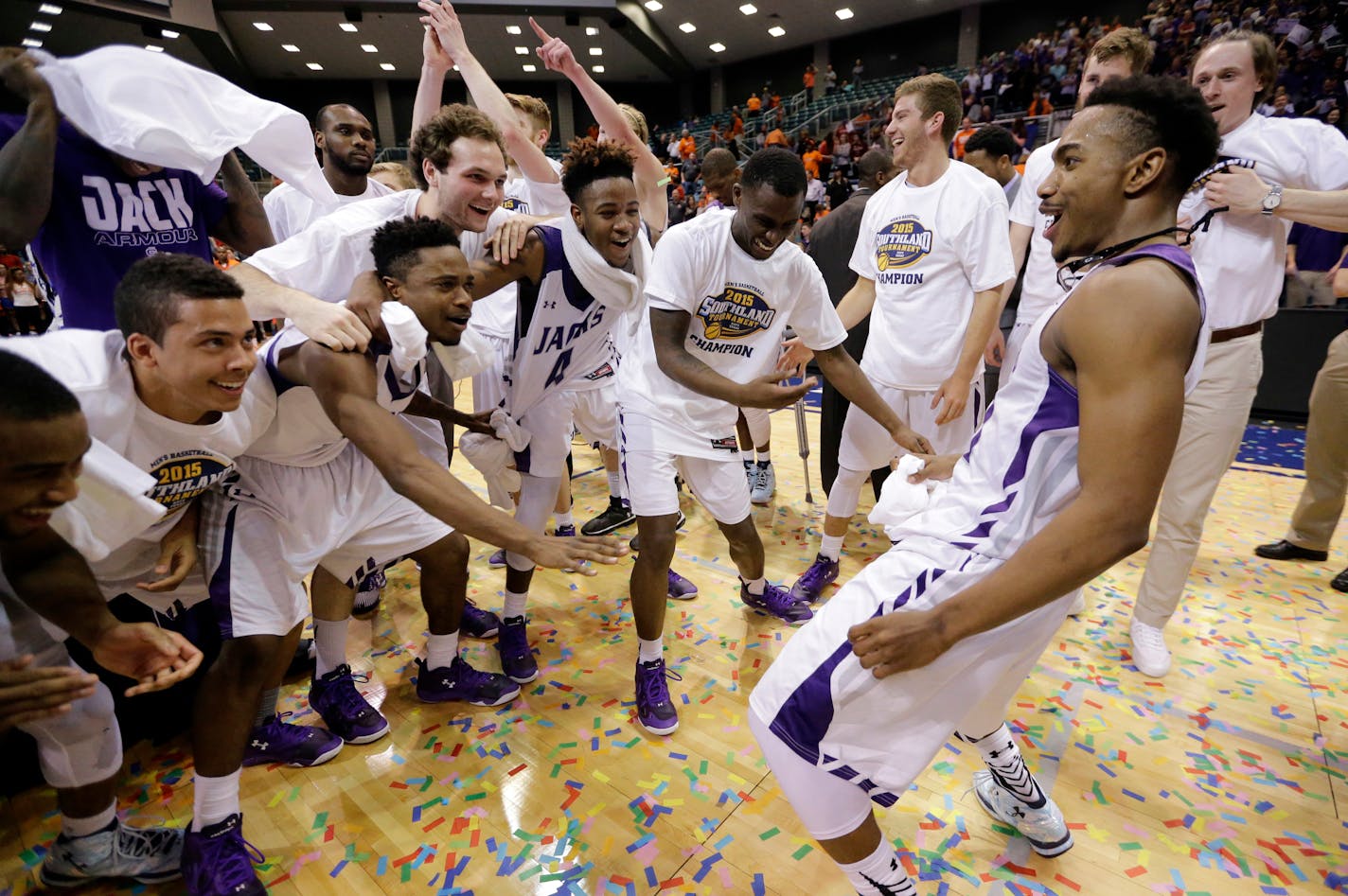 Stephen F. Austin's Trey Pinkney, right, dances as he celebrates with teammates after an NCAA college basketball game against Sam Houston State in the championship of the Southland Conference tournament Saturday, March 14, 2015, in Katy, Texas. Stephen F. Austin won 83-70. (AP Photo/David J. Phillip)