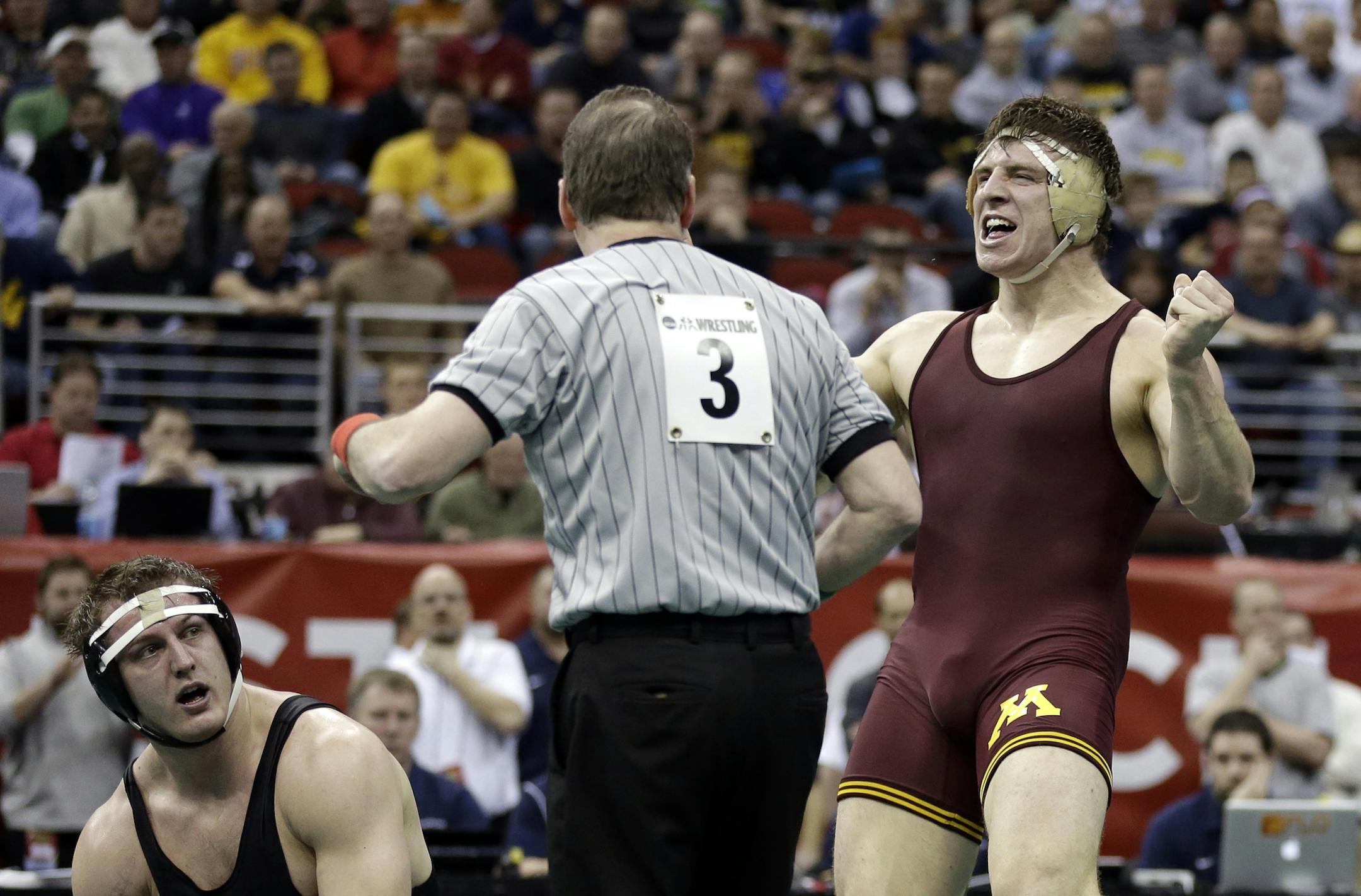 Minnesota's Anthony Nelson, right, reacts after defeating Oklahoma State's Alan Gelogaev, left, in their 285-pound semifinal round match at the NCAA Division I wrestling championships, Friday, March 22, 2013, in Des Moines, Iowa. (AP Photo/Charlie Neibergall)