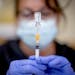 A nurse fills needles with the Johnson & Johnson vaccine in Eden Prairie in April.