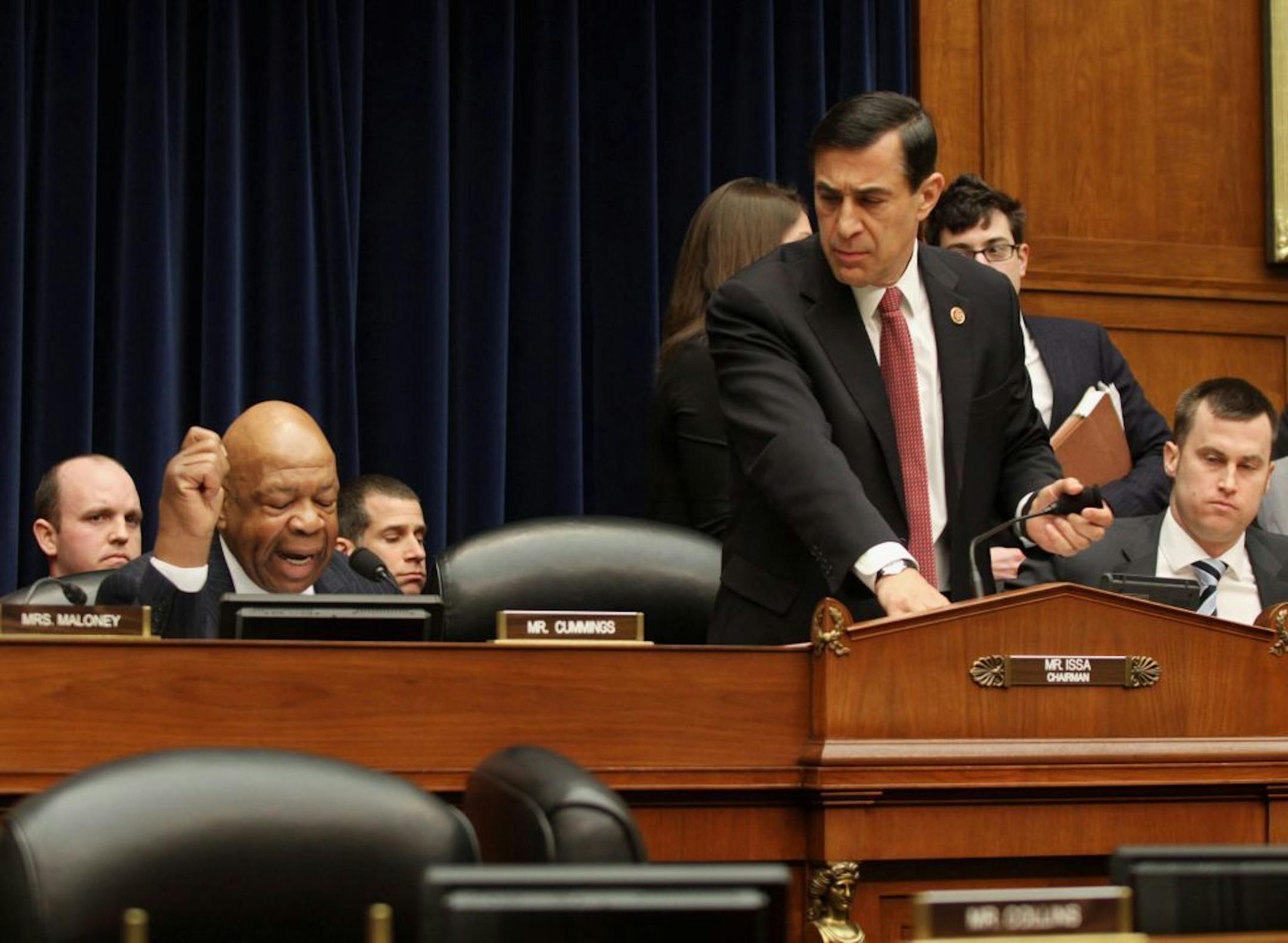 House Oversight and Government Reform Committee Chairman Rep. Darrell Issa, R-Calif., right, leaves as the committee's ranking member Rep. Elijah Cummings, D-Md., left, begins his statement on Capitol Hill in Washington, Wednesday, March 5, 2014.