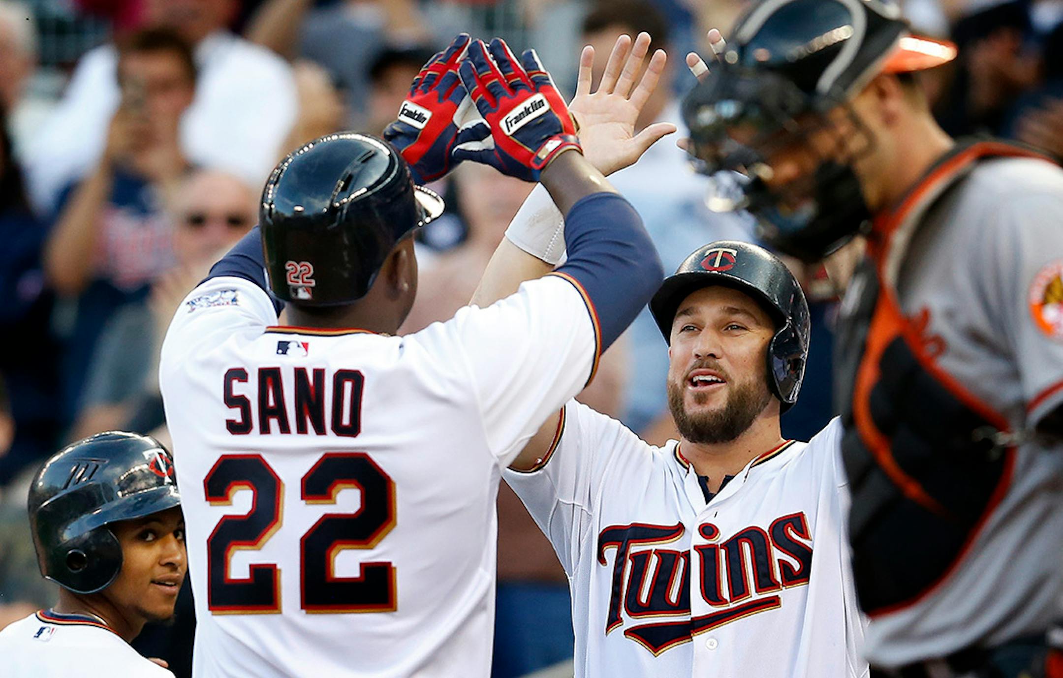 Sano was greeted by Trevor Plouffe (24) after he hit the first home run of his career on July 7.
