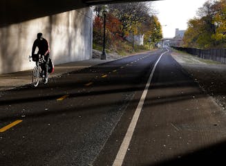 A man cycles on the Midtown Greenway in Minneapolis.