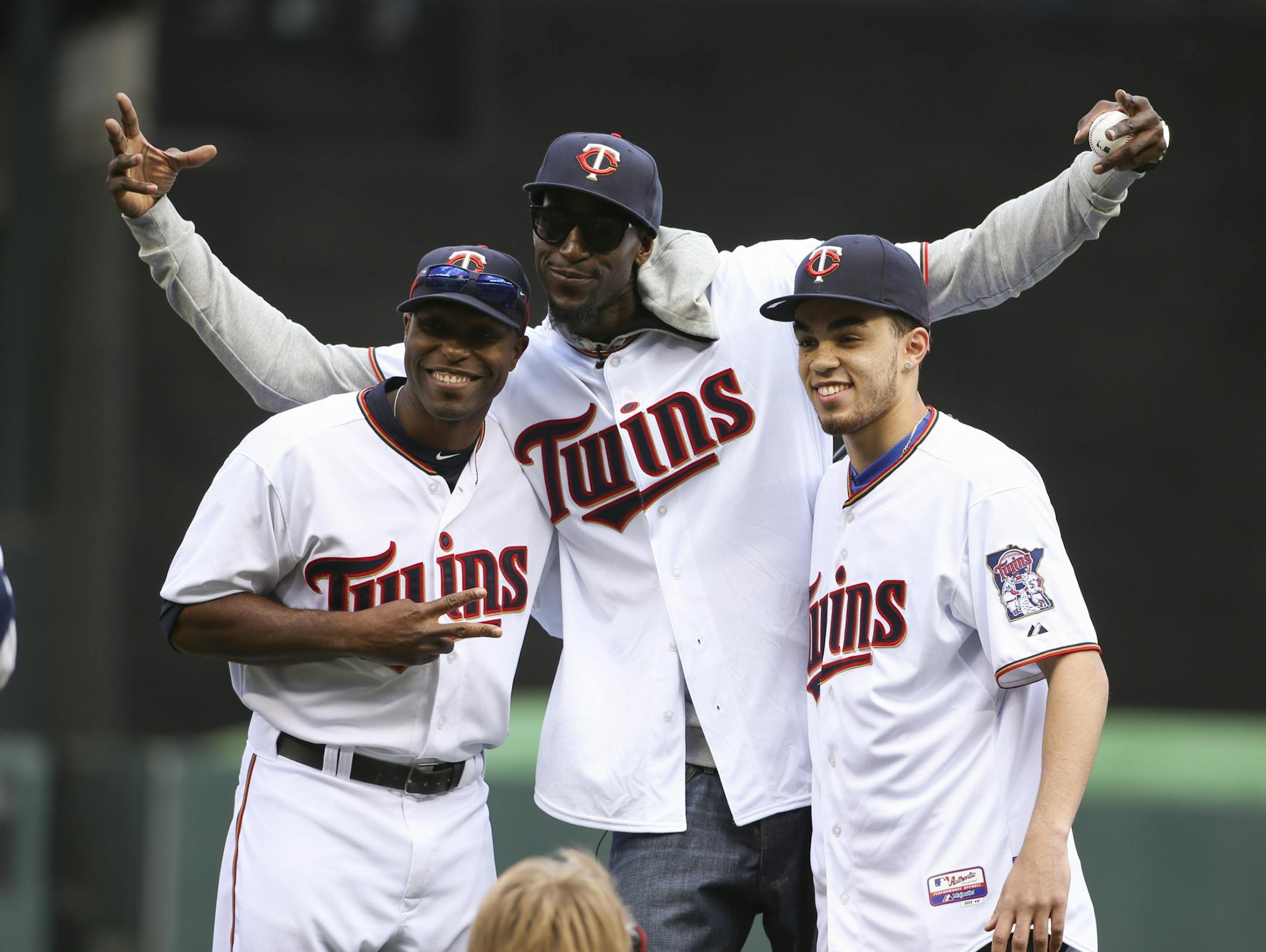 The Twins' Torii Hunter, The Wolves' Kevin Garnett, and Duke's Tyus Jones, from left, posed for a photo after Garnett threw the ceremonial first pitch to Hunter before the home opener Monday afternoon at Target Field.
