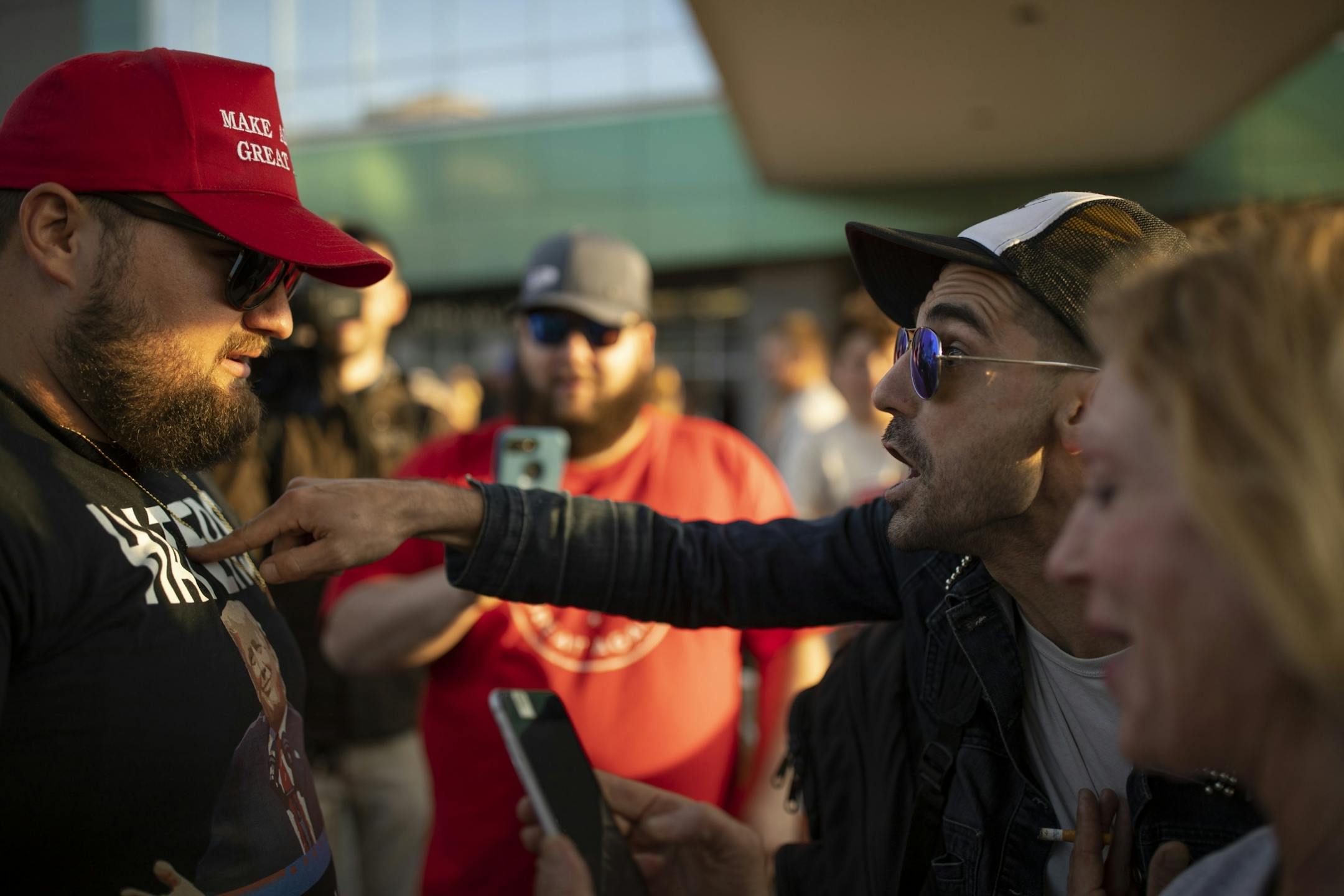 A Trump supporter and an anti-Trump demonstrator exchanged words as the crowd that attended the rally exited Amsoil Arena.
