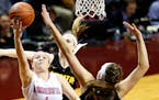 Gophers guard Rachel Banham, shown attempting a shot against Iowa on Feb. 15, scored 52 points in a 114-106 loss to Michigan State on Sunday.