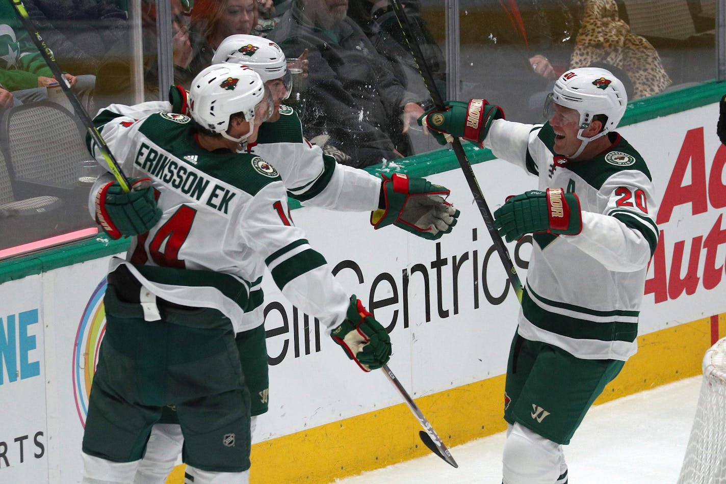 Wild left wing Marcus Foligno (17), center Joel Eriksson Ek (14) and defenseman Ryan Suter (20) celebrate a second-period goal by Foligno