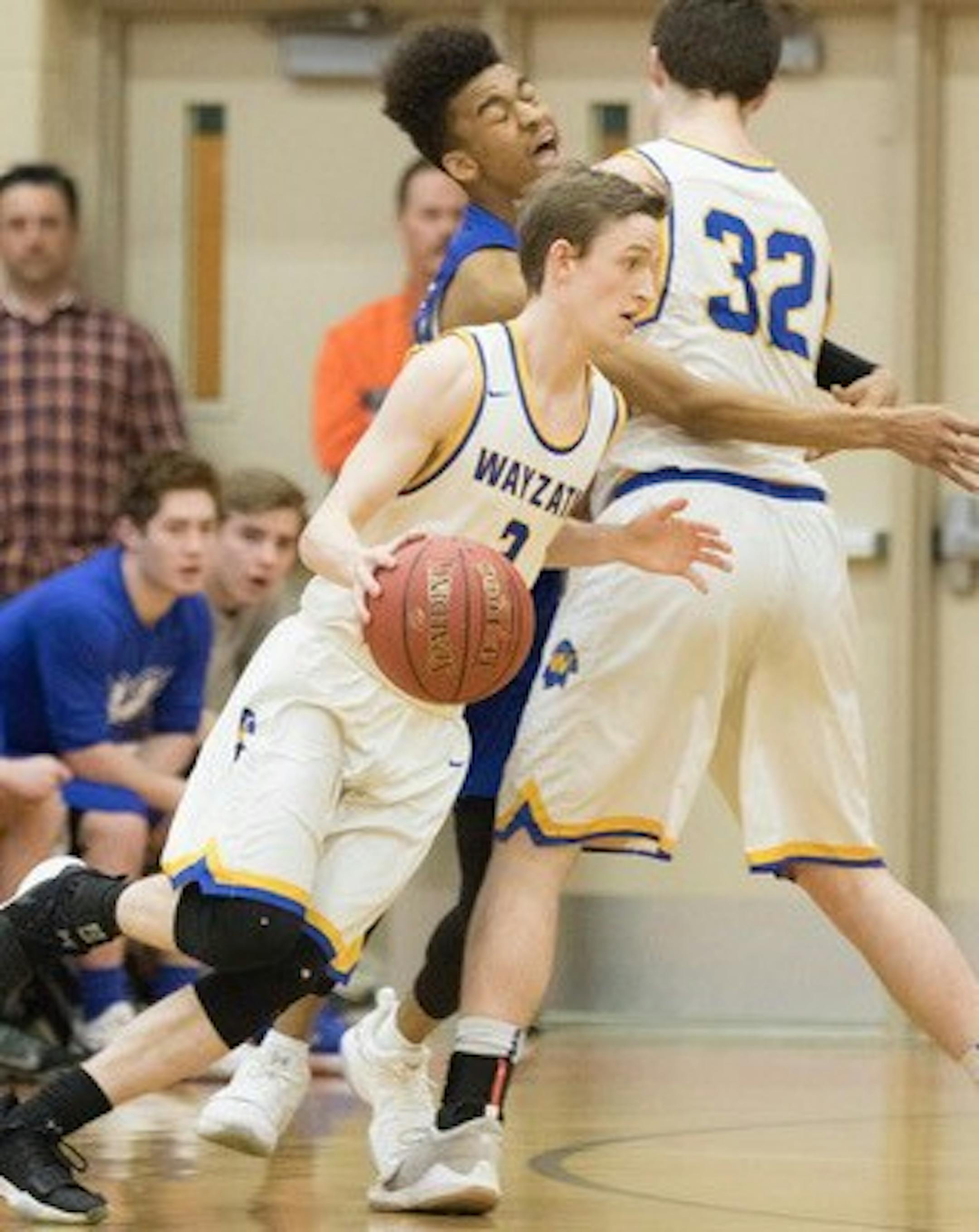 Wayzata guard Jacob Beeninga moves along the perimeter with help from Tanner Jonas against Hopkins Wednesday night. Photo by Jeff Lawler, SportsEngine
