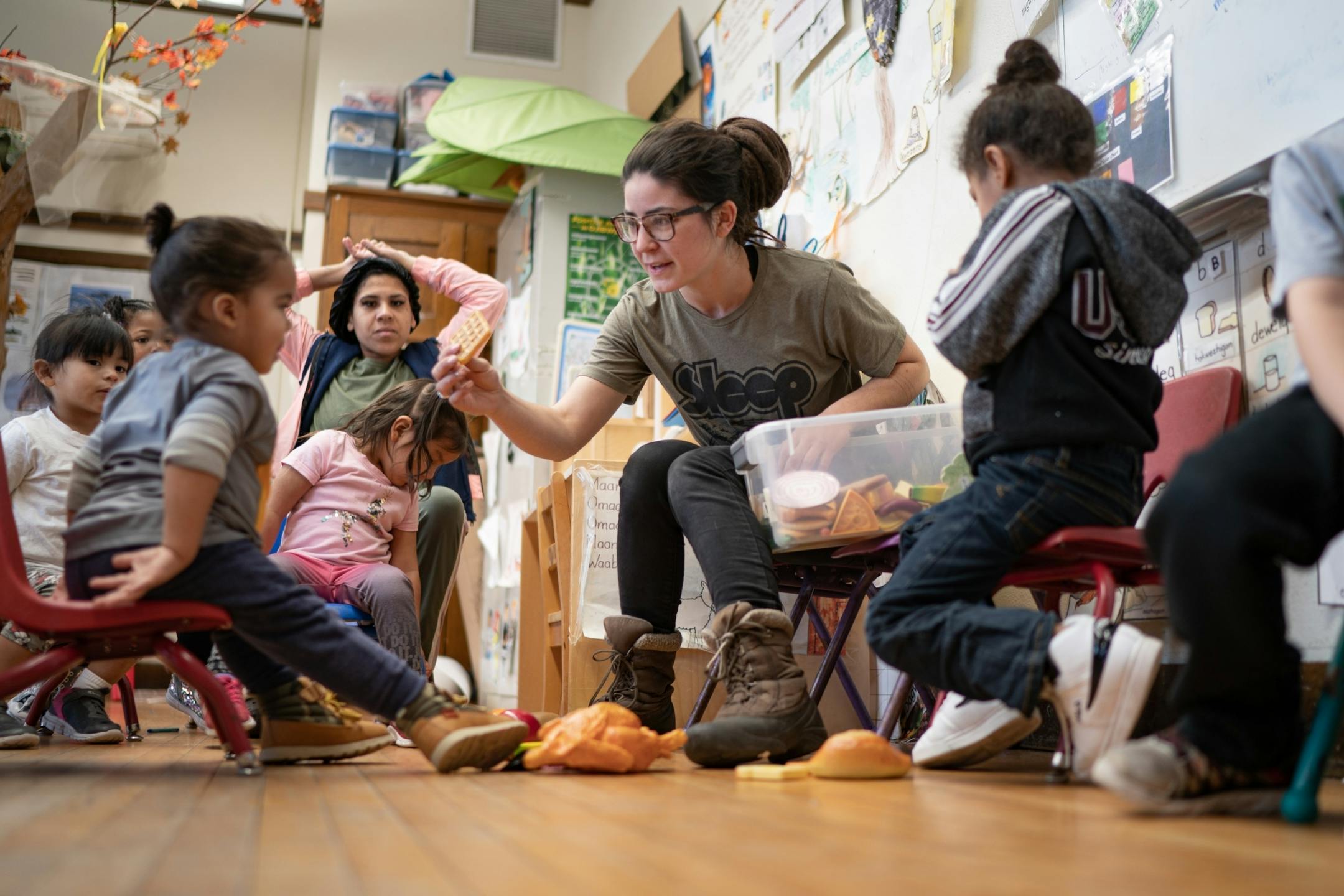 Ojibwe teacher Liz Zoongwegiizhigook Zinsli led an Ojibwe immersion class for students from 18 months to 5 years old, at Four Directions school. This week's theme was food groups where students named common foods speaking Ojibwe.