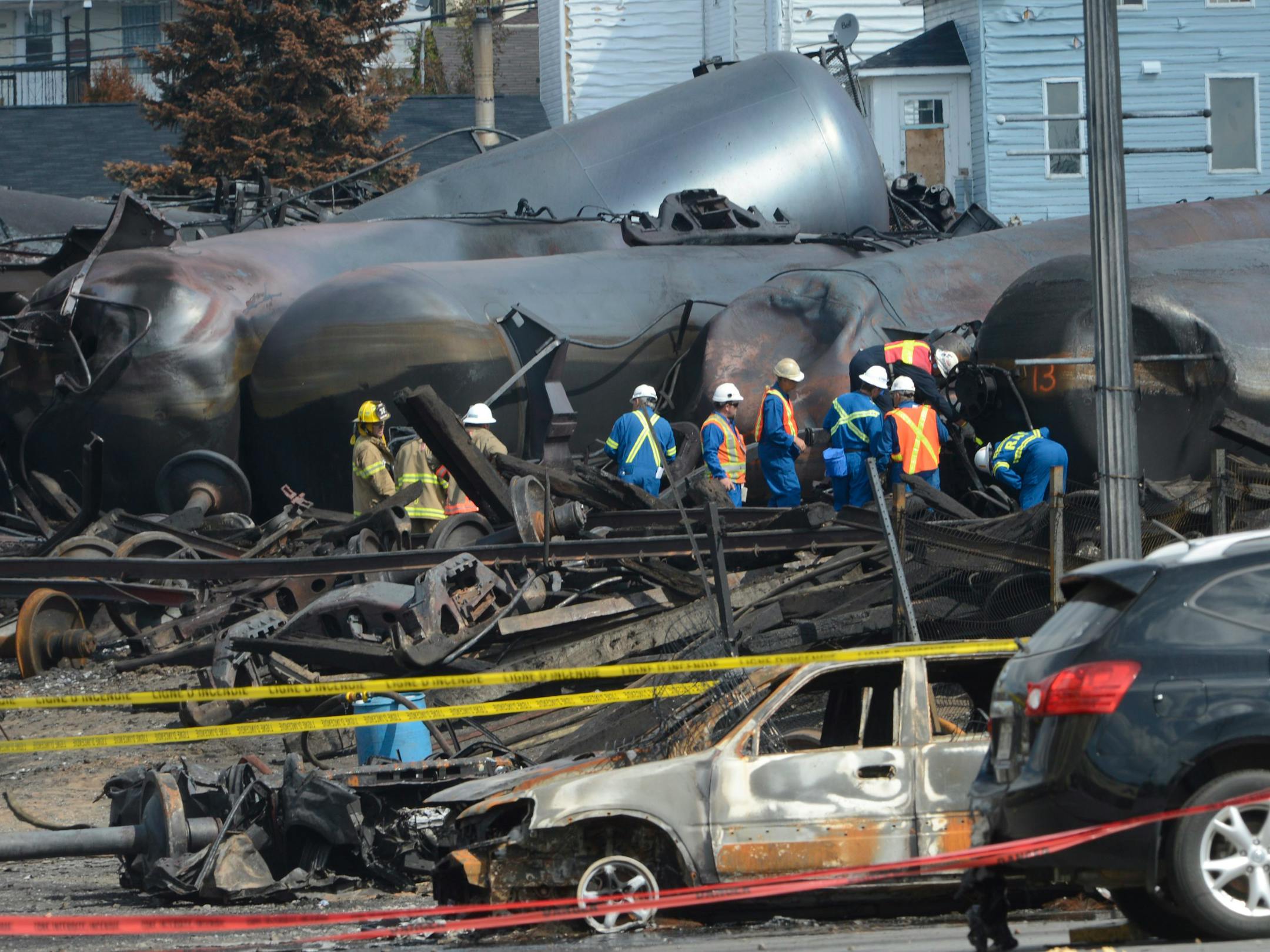 July 6, 2013: Emergency workers examine the aftermath of a train derailment and fire in Lac-Megantic, Quebec, Canada. Forty-seven people were killed.