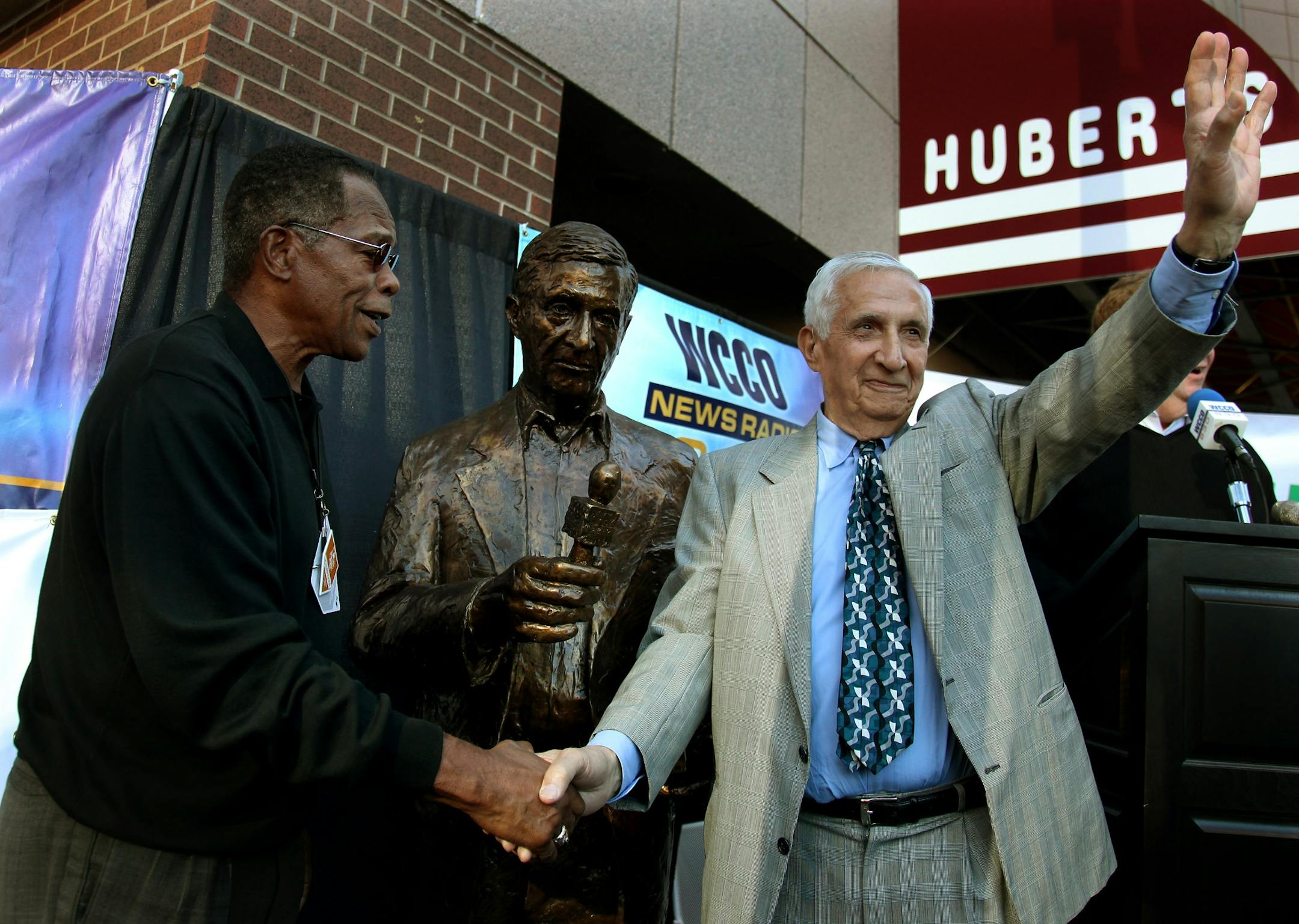 Sid Hartman was greeted by Hall of Famer Rod Carew after he unveiled a statue of Hartman outside the Target Center.