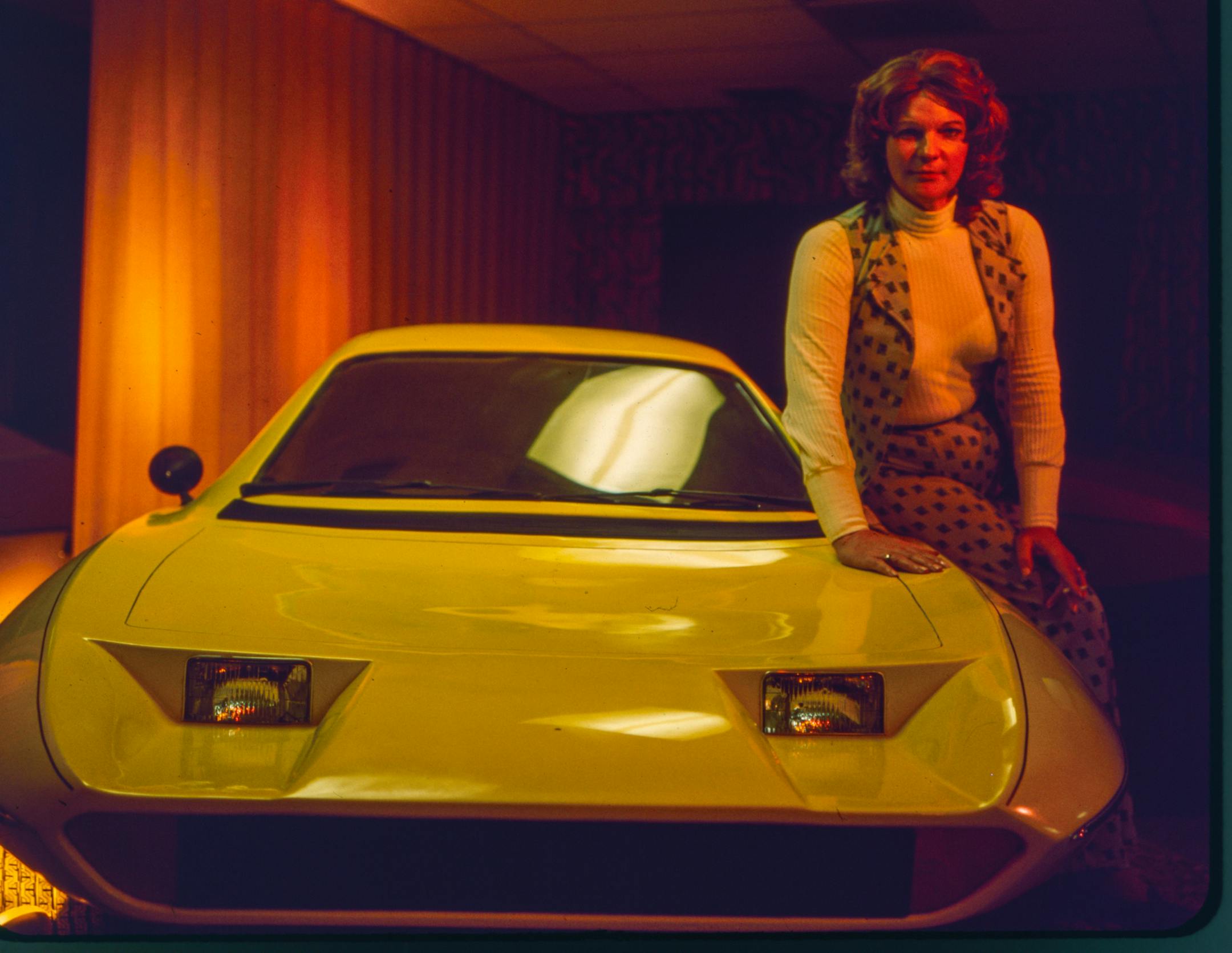 Elizabeth Carmichael posing next to the Dale Automobile.