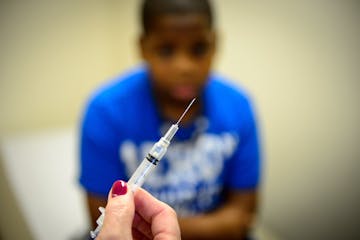 Courtney Carter, 12, received two vaccinations from LPN Kathy Schwalbe at Park Nicollet Clinic‚ÄîBrookdale in Brooklyn Center. On the left is brot