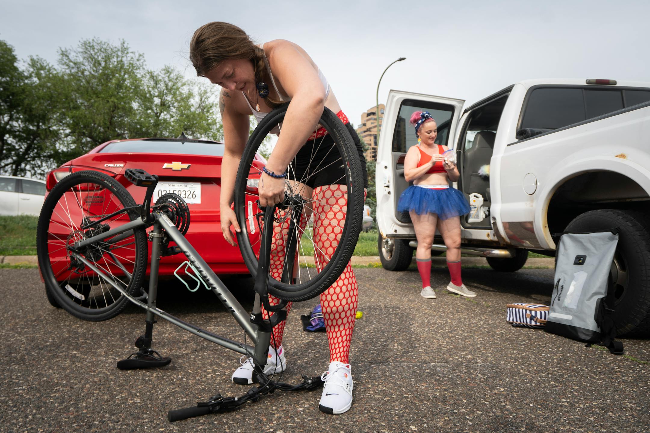 Lisa Van Risseghem attaches her bike wheel in preparation for the annual Freedom From Pants Ride in Minneapolis.