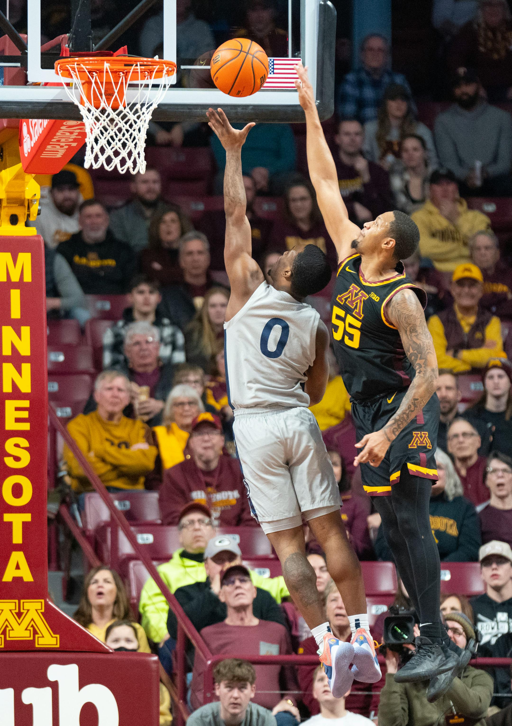Minnesota guard Ta'lon Cooper (55) blocks a shot attempt by Penn State guard Kanye Clary (0) in the first half.