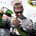 Carl Edwards sprays sparkling wine after winning the NASCAR Sprint Cup Series race Sunday, June 22, 2014, in Sonoma, Calif.